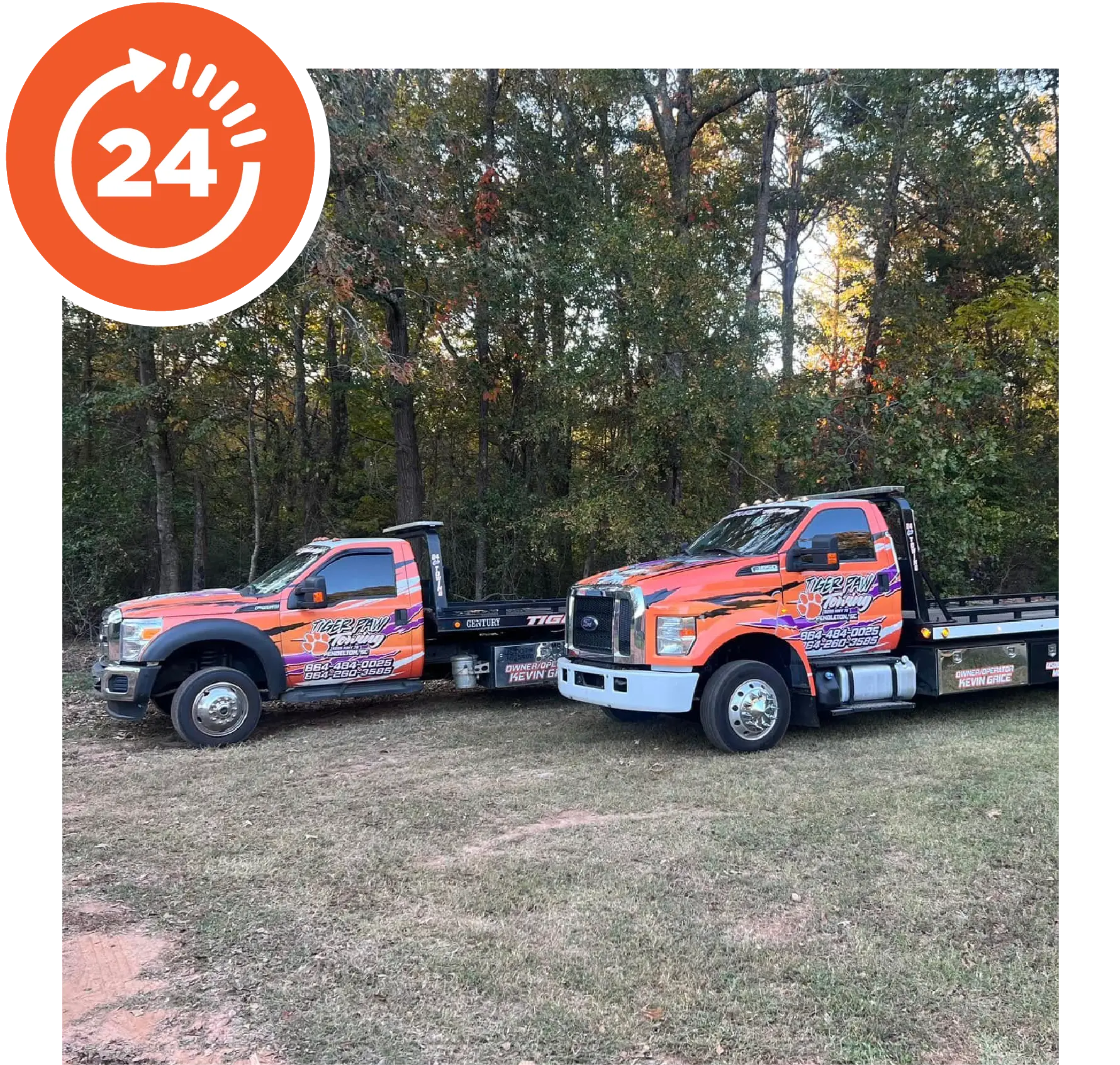 Two Tiger Paw Towing trucks side-by-side on field.